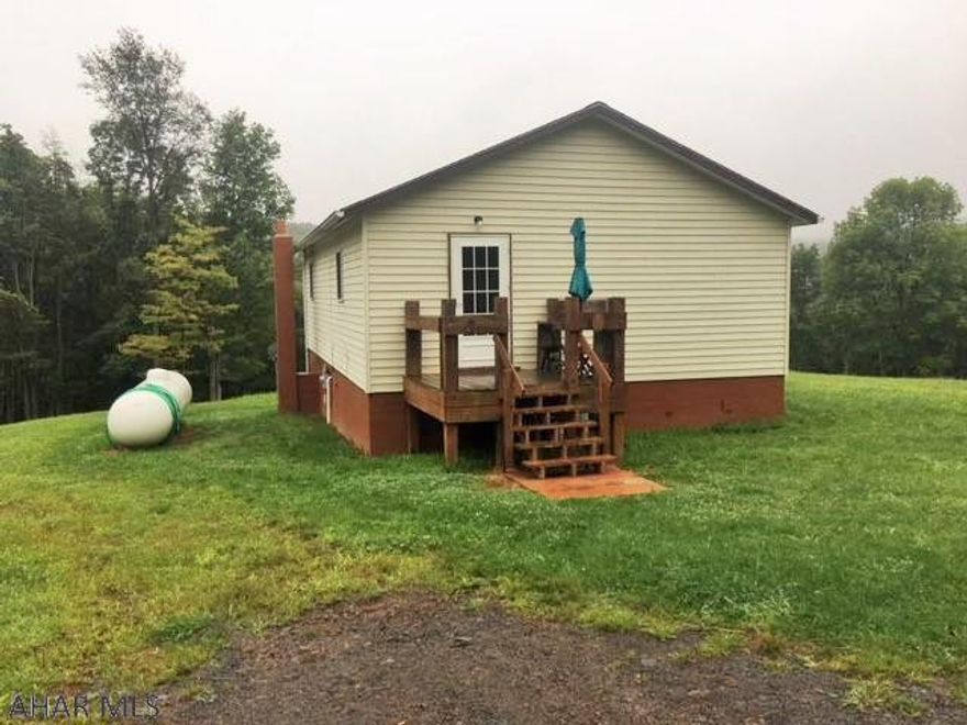 Almost 70 acres of serene paradise. 10' deer fence surrounds the entire property creating a unique compound. Trophy deer were once raised on the property and many still roam. Well built cabin is secluded on the property. 2 BR, 1 BA with open kitchen/living room. Move in ready for you to live the simple life away from everything. Property has 1 pond and 1 watering hole. Several outbuildings including a butcher shop. Plenty of room for gardens. 2 gates on the property for access and several cleared spots perfect for building sites. Cleared area at top of property with water, septic and electric ready to go. One of a kind property, priced right!