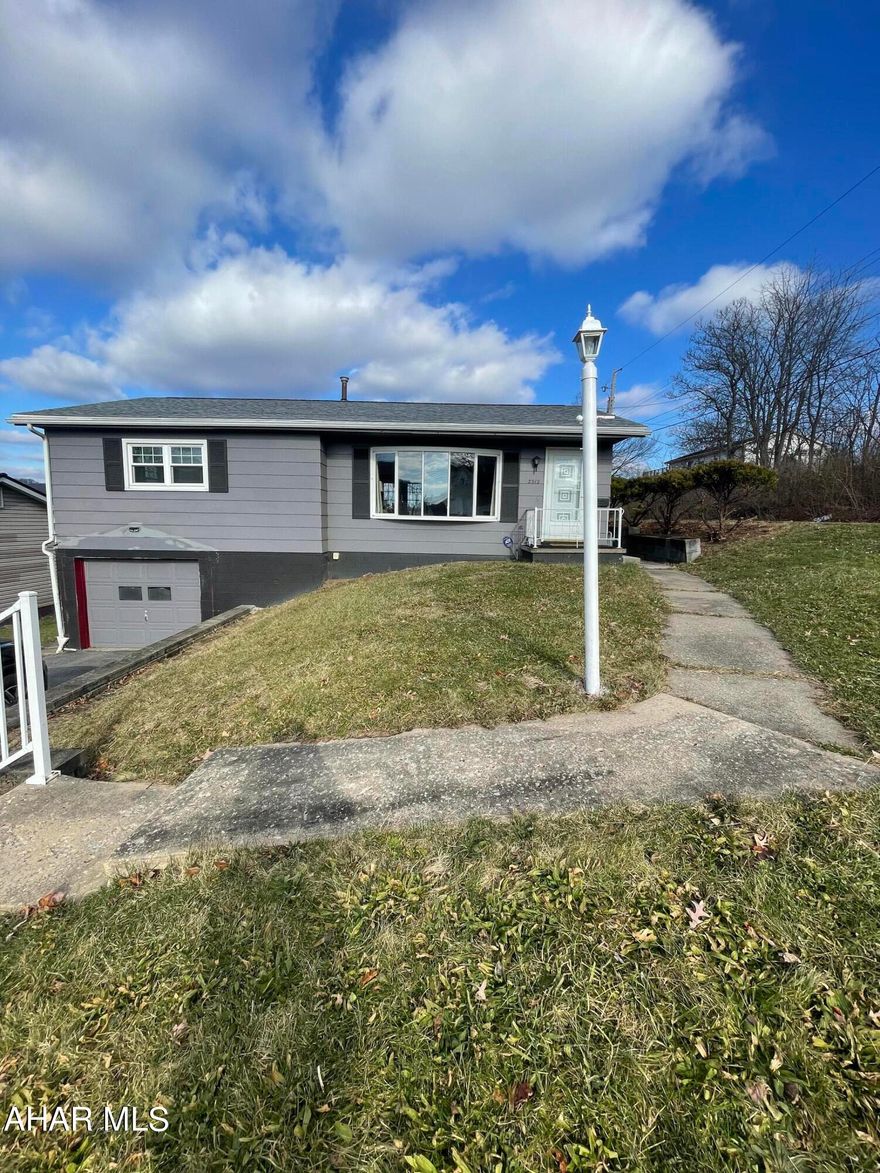 This raised ranch is super welcoming with a number of updates! Located just minutes from Penn State Altoona Campus, Sheetz, and many great eateries! The main floor welcomes a plethora of natural light with a large bay window, beautiful hardwood floors, and fresh paint throughout! An absolute perfect starter home or downsize. The master bedroom is quite large, featuring his and her double closets. The laundry room is right off of the master and features a handicap accessible shower/commode. The dining room has double doors that lead out to a concrete patio, perfect for grilling all summer. The yard is fenced and sizable. The kitchen features plenty of lighting, and oak cabinets. The full basement offers several rooms, and a 1/2 bath. A second bedroom could be set up downstairs, also. Updates include a BRAND NEW roof, all newer windows, new hot water tank, and interior/exterior paint. Move-in ready. Motivated seller, schedule your showing!