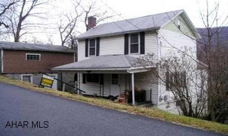 Two-story w/ 1-story annex w/ full basement. Detached garage w/ full basement. Vinyl siding, metal roof on house, porch has shingled roof. Some storm windows. Living room has open staircase, eat-in kitchen & BR or den on first floor. Second floor has 2 BR & full bath. Some newer drywall wall finishes. 2001 new oil furnace, gas H2O heater, central air.