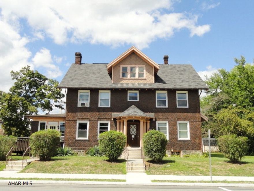 Large 3 story brick, 5/6 bedroom, 3 bath home located on large corner lot. Great single family residence or multi=family investment property. 3 floors w/large rooms and original wainscoting, trim work and hardwood. Many amenities: Wood burning fireplace, bright sunroom and off-street parking. This is a must see property in a central location.