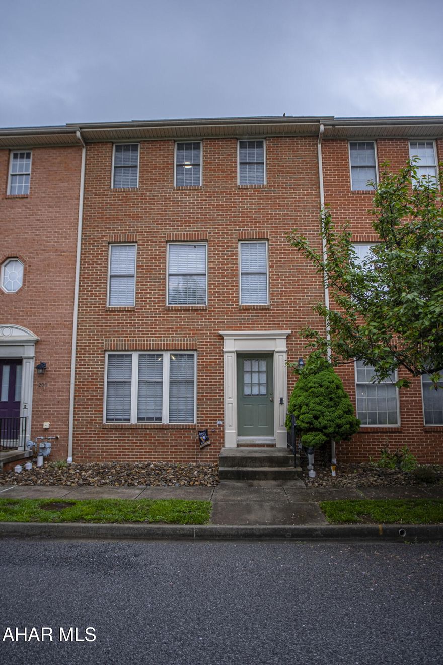 Check out this well-kept townhouse in Holliday Hills! The entry level features new luxury vinyl floors and a versatile living space that can serve as a family room, home office, or guest suite complete with a full bath.

Upstairs, you'll find an open kitchen with stainless appliances, flowing into a bright living and dining area with beautiful hardwood floors and a convenient half bath.

The upper level offers two spacious bedrooms with large closets, a full bath with plenty of storage, and even additional storage space in the attic. Handy laundry chutes on both levels, central air, and two designated parking spots in the back add extra convenience.

Enjoy access to the community playground and picnic area perfect for outdoor relaxation. Don't wait, schedule your showing today!