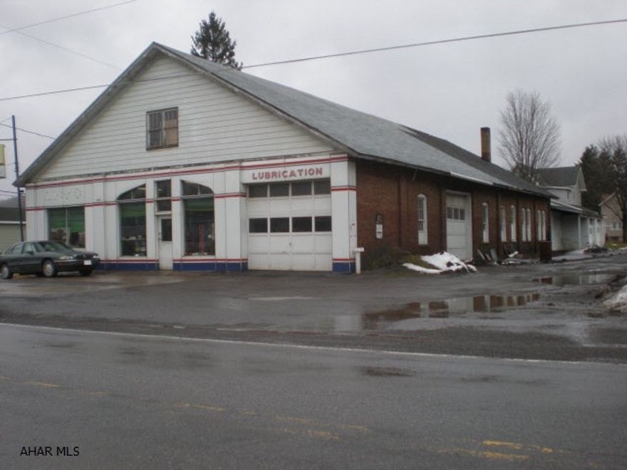 Over 5,000 sq ft with attic storage. Additional two car garage at rear of lot. Interior concrete floor and front office/recption area. Tanks were removed (DEP letter available). Nice garage for work or storage. Owner retiring.