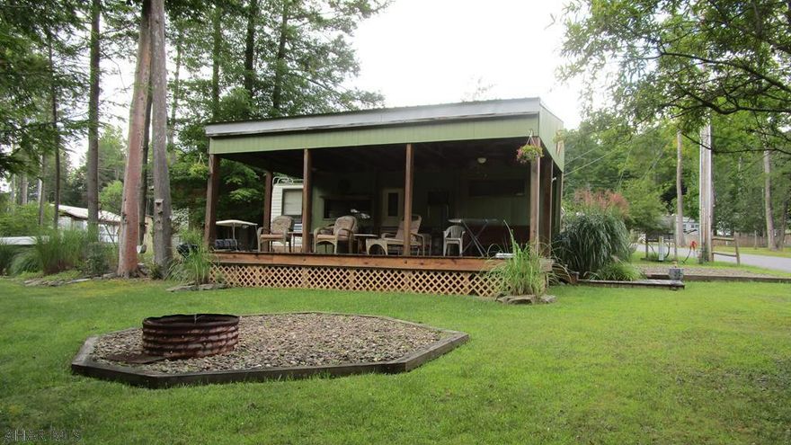 Camping is about being outdoors and this campsite offers a lot of that.  Whether it is the sizeable lot bordered for privacy, the small creek passing by or the huge covered deck you will have space to enjoy the outdoors.  Fifth wheel camper sleeps five.  Located in Glendale Yearound, a gated recreational community adjacent to Prince Gallitzin State Park / Glendale Lake and six miles from Rock Run ATV Park.