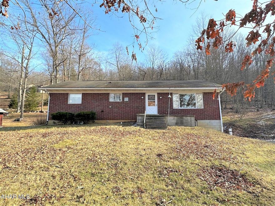 This brick ranch home is located just minutes from downtown Bedford but in a peaceful country setting. The main level of this home offers a living room with picture window, kitchen with large built-in, three bedrooms, and a full bath with laundry area. Basement is partially finished with a family room, kitchen area and an integral garage. Updated ''Carrier'' propane furnace with central air-conditioning, 200-ampere electric (being updated now), hardwood floors and oak trim. Interior stairwell to a large unfinished attic perfect for storage. Covered rear porch perfect for relaxing and enjoying your new home!!