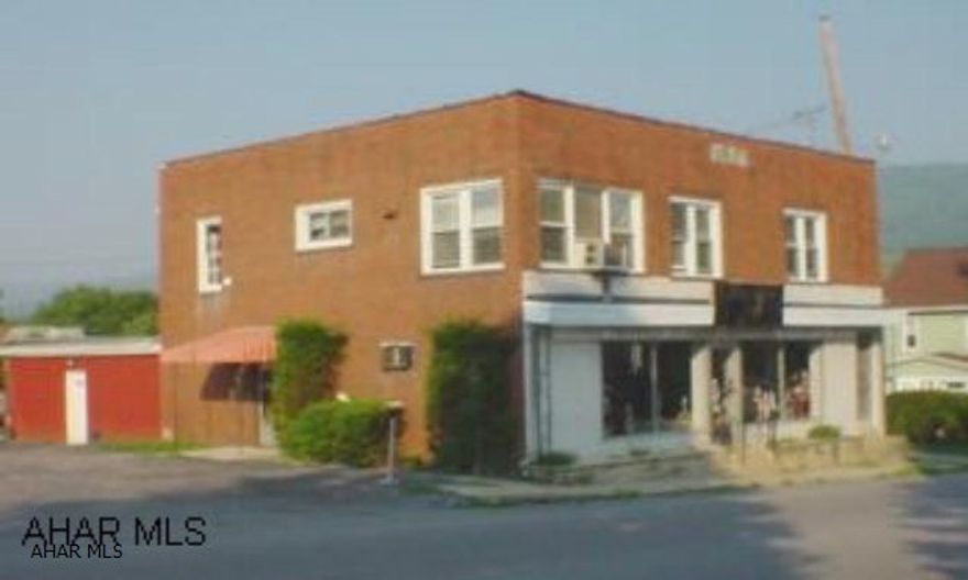 2 story brick building with parking lot. 1st floor is approx. 1700 sq. ft. and includes retail space, 2 offices spaces & large storage area. 2nd floor has a 2 bedroom, 1 bath apartment with new carpet, ceramic tile, new oven, washer/dryer hook-ups, & all new windows. Main roof is rubber, approx. 13 years old and rubber roof over storage area approx. 2 years old. Agent is related to seller.