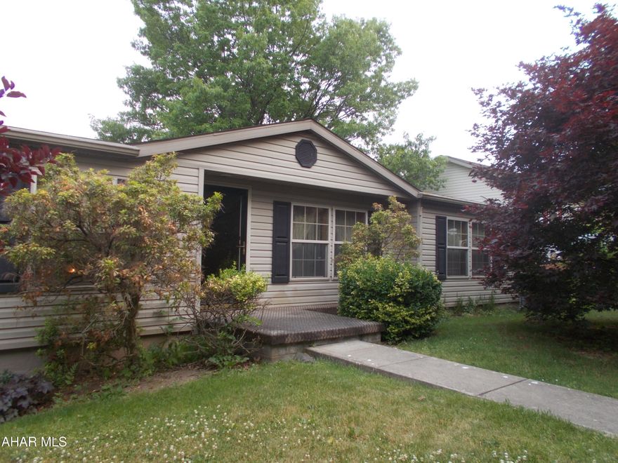 This manufactured home is spacious with a split floor plan with the primary bedroom and bath on one side and 2 bedrooms and bath on the other side.  Spacious eat-in kitchen with sliders to large deck, private back yard and open to family room with stone gas fireplace.  A formal dining and living room, a huge easy-to-finish basement, private back yard, walking distance from Garfield Park. This is a must-see home!