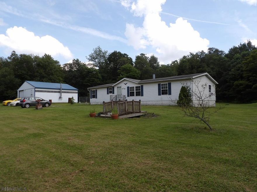 Spacious 3 bedroom 2 bath double wide on a permanent foundation on 2.9 acres in a rural area of Cambria county. This property features a large above ground pool and large detached heated garage/ workshop with a half bath. The hydraulic lift, air compressor and tool benches are included!
