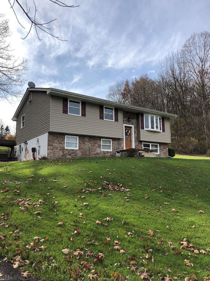 Upon entering this split level you can see that it is beautifully maintained, large and offers plenty of space to entertain family and friends both inside and outside. This unique property offers two separate living areas if desired.  House was updated in 2011. Both kitchens and baths were updated. Kitchens offer plenty of cabinet and counter space. Hardwood flooring in living room extends down hallway into the bedroom. Windows, heat, siding, insulation and two car garage all new in 2011.  Updated all of the lighting fixtures.  The well has an easement from neighboring property.  Great area.  Call today to schedule your showing.