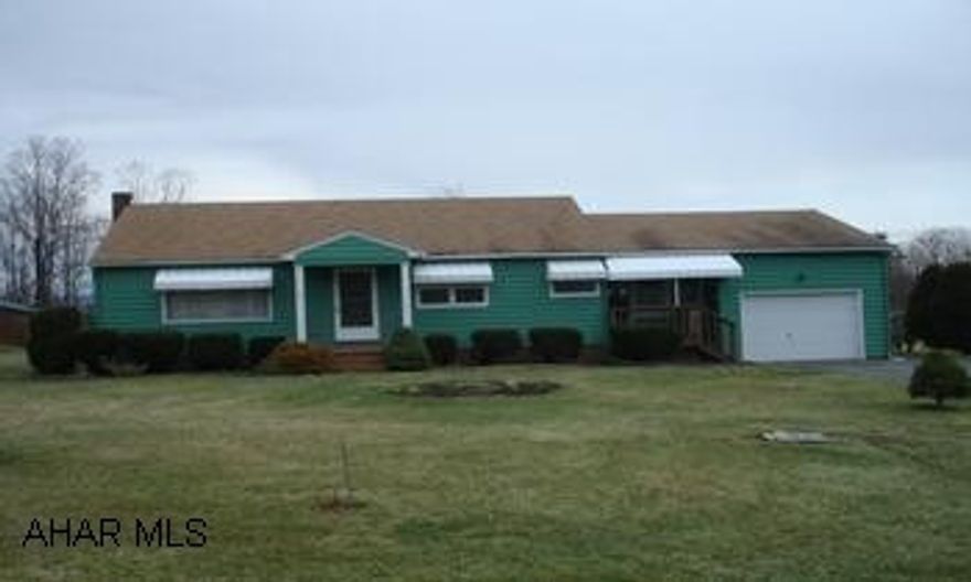 Ranch home with a one car attached garage in the country. Ranch home with a one car attached garage in the country.