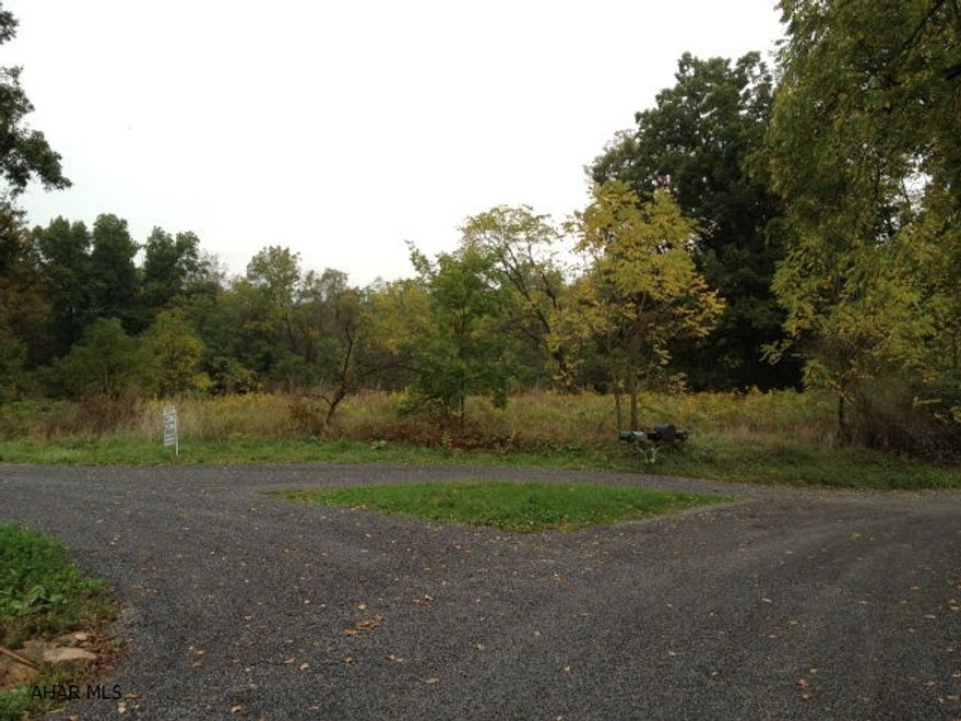 This land is a nice level 2.1 acres to build on with road access from two directions.  Mature trees border two sides of the property and minimal clearing needs to be done. A well in on the property and an old septic was installed in the 80's.  This septic would not be usable to today's standards.  A great piece of ground to build a home on.