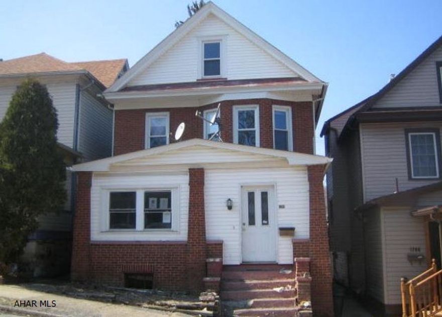 Spacious two story Brick home in Altoona in need of some work. Features large living room w/ FP stained glass windows and natural wood trim. Spacious kitchen, formal dining room, possible 4th bedroom in the attic and 1 car detached garage. Needs some work but could be your dream home.