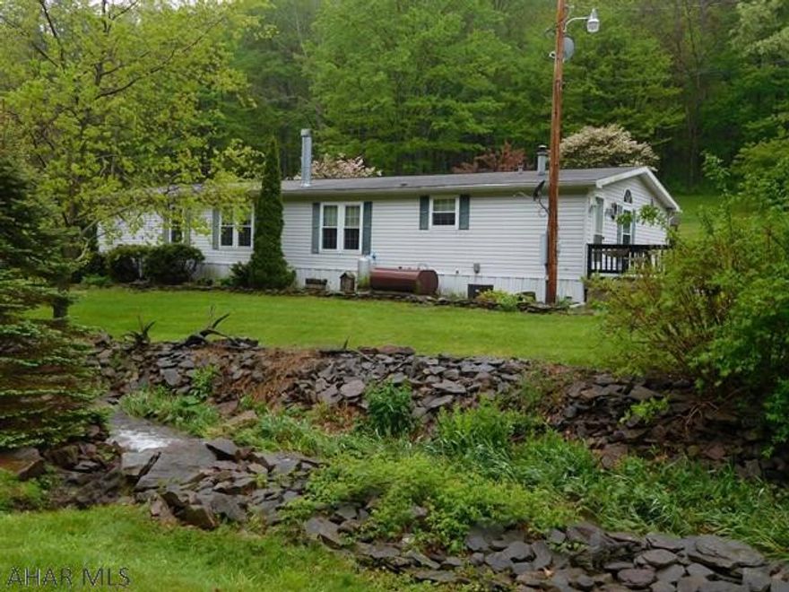 Maintained 4 bedroom, 2-full bath doublewide on 0.90 Ac. Plenty of closet & storage, includes appliances and shed. Oil FA heat, woodburn fireplace, flower beds and a year round stream.