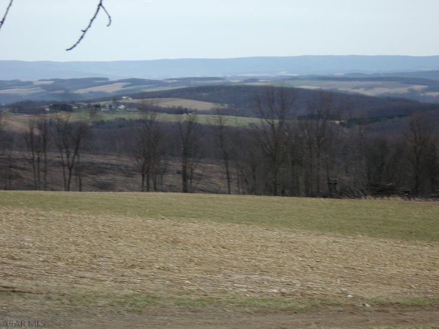 Build Here!  2 mostly open acres w/ well & septic already in place.  The ground is sloped w/ a level area on top.  This land is ready for your get away, full time home, or hunting cabin. (or bring your RV and camp!)   Much evidence of wildlife activity.  Whatever you build, the views will take your breath away.  Watch the sun rise and set looking over the everchanging landscape.  Enjoy the quiet that can only be found in the country.