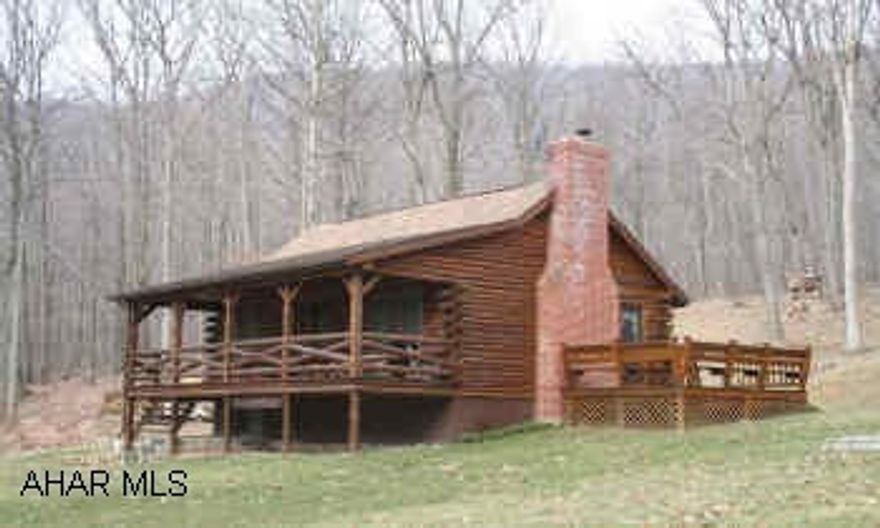 Log House ideal for second home; located on 4.505 acres, private wooded setting with the convenience of being close to town. Kitchen, DR/Great Room with high vaulted ceilings and cozy woodburner, BR & bonus room on main level; also has a loft bedroom. Large covered front porch, 12x12 side deck, garden shed.
