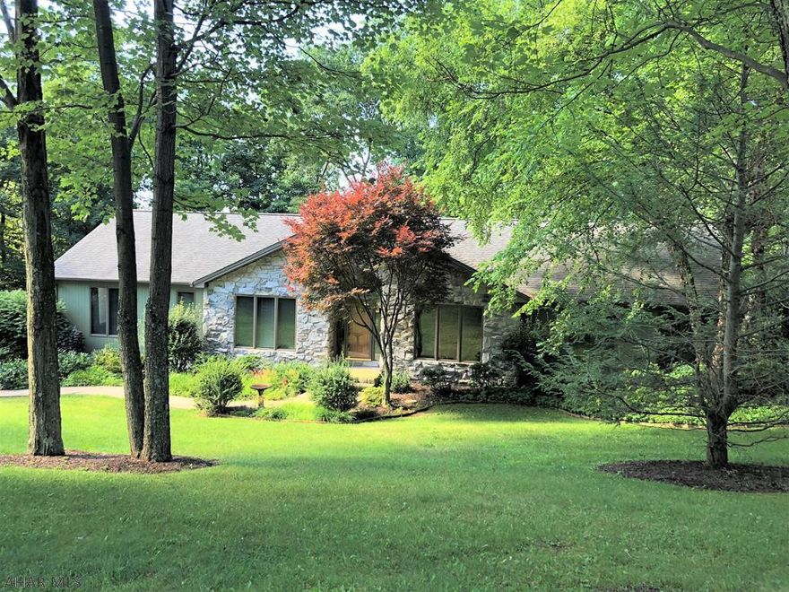 Spectacular 1 story, on 1 acre private lot,  w/ open floor plan, brings the outside "in"  The spacious living room is "stunning" w/ vaulted ceilings, fireplace and a window wall that brings the outside in. Another "must see", is the large Master Suite, which has 2 walk-in closets and a beautiful Master Bath with 2 vanities /sinks, heated tile floors and trimmed in granite. On the main floor there is 3 bedrooms and an office/bedroom. There is a Bathroom for every bedroom!  The Lower level could  be an in-law suite or teen oasis: with a family room, full kitchen, bar, fireplace and bedroom with 3/4 Bath. Outside is a Two tier rear deck, 35 X 12, with newer Awning and Hot Tub below. Also,Off the Kitchen is a 3 season room. Newer furnace, AC, lighting and cement driveway. New Hot Water Heater