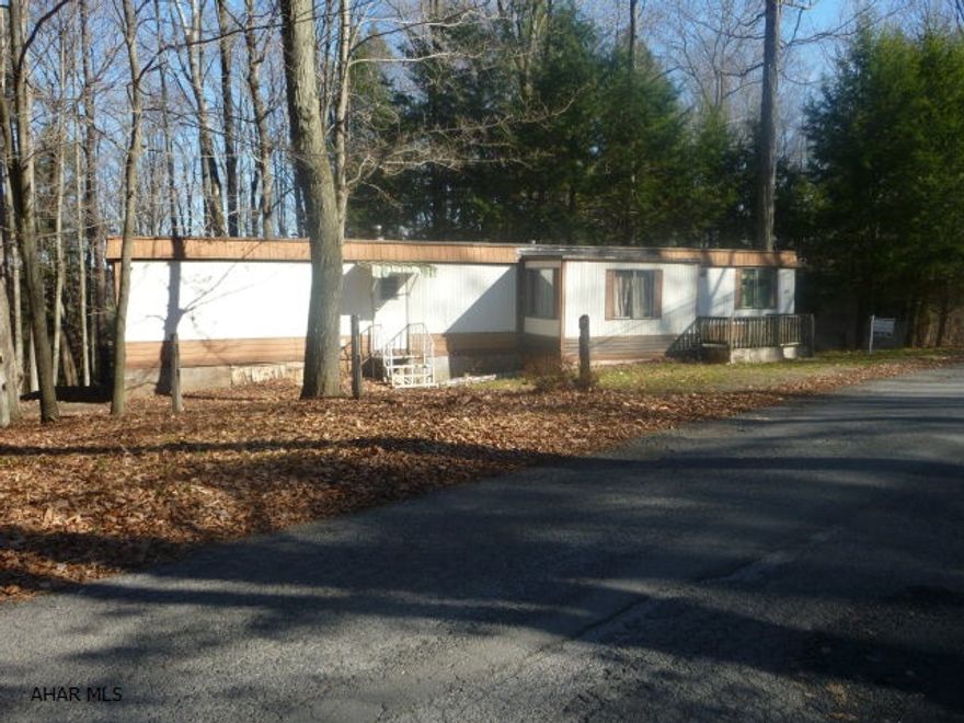 Affordable first home or camp.  Needs work but owner installed new piping.  Kitchen is eat-in, living room is spacious with 6' x 12' addition.  Back yard is wooded and private.  Located in Glendale Yearound - garbage included in Property Owners dues as well as use of pool and other amenities.  Security force.