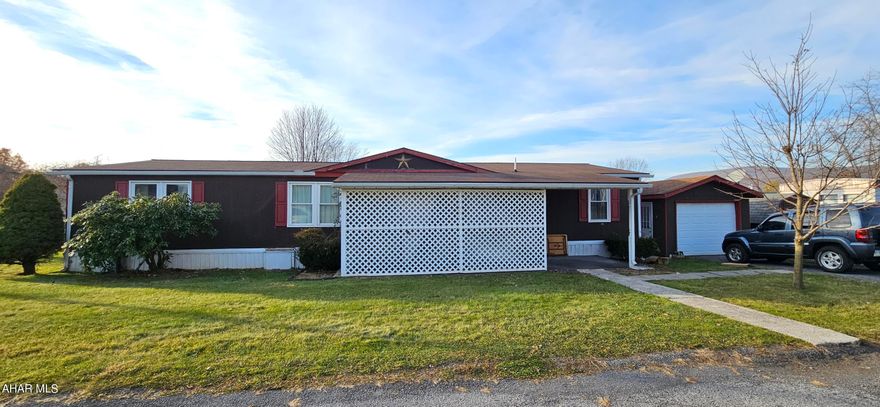 What a great find.  Very spacious one-story living.  Enough room for everyone..  Two living rooms with vaulted ceilings.  2 1/2 baths.  Convenient laundry room.  One car garage plus a storage shed and outdoor storage containers.  Replacement windows throughout.  Central A/C. Extremely low taxes are an additional bonus.  Lot rent $418 includes garbage.  Seller is a licensed real estate agent.