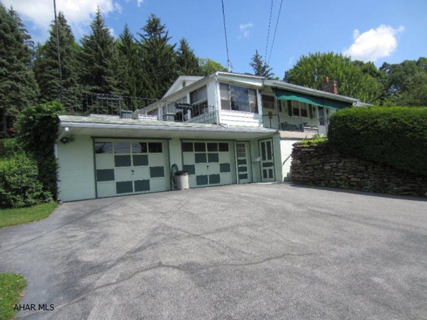 A very clean and well maintained raised ranch house with lots of extras.  Sits on .61 acres, in quiet location, with an awesome view to the north and west.  It has 3 bedrooms, 2 full baths, hardwood floors and lots of closet and storage space.  Family room in basement w/wood burner.  Pool table/accessories.  Two car attached garage, in-ground pool, hot tub and RV garage with storage.  Also has single wide, Holly Park trailer that could stay or be removed.  Currently is occupied.