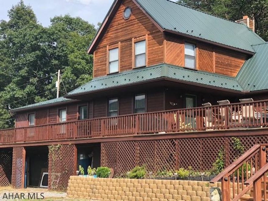 STUNNING VIEWS!!!!  Cedar home with metal roof, 3 bedrooms, 3  bath, hardwood floors, French doors to dining room, crown moulding, propane fireplace in first floor master, 2 closed in porches, 2nd master suite on 2nd floor, central air, gorgeous stone fireplace in LR, tons of storage, owned water softener, several heat sources, partially finished attic, integral 2 car garage, shed and above ground pool. This property is close to state game lands.