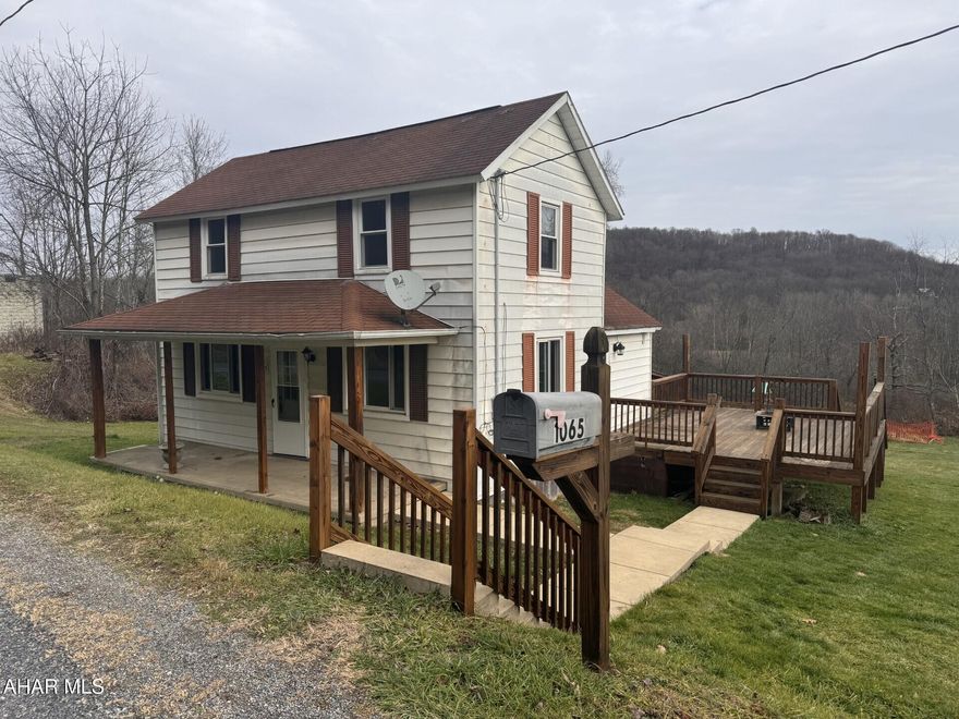 2 story aluminum sided 3 BR, 1 bath home on 0.63 acres. Remodeled eat-in kitchen & LR/Dining area with tongue & groove wood walls.  Updated bathroom.   Oil HW heat. Front porch and large wood side deck.