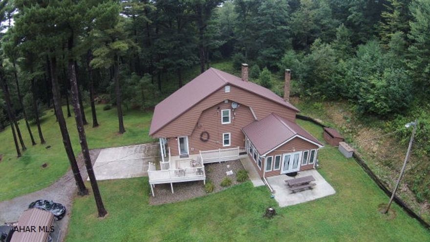 Are you looking for privacy?  Would you like to be surrounded by state game lands?  Now is your opportunity to own this retreat home on 4 acres. Do you like to fish?  How about your OWN trout stream right on the property. You can enjoy this home for your getaway or live in it full time with its completely equipped kitchen. Large sleeping area with full bathroom, living room and dining area. Oil heat with back up electric and generator. There is a large vinyl deck to sit outside and enjoy nature at its finest. New vinyl siding and windows. Includes security system. Excellent hunting and fishing. Twenty five miles from University Park and State College, Pennsylvania and 35 miles from Altoona, Pennsylvania.