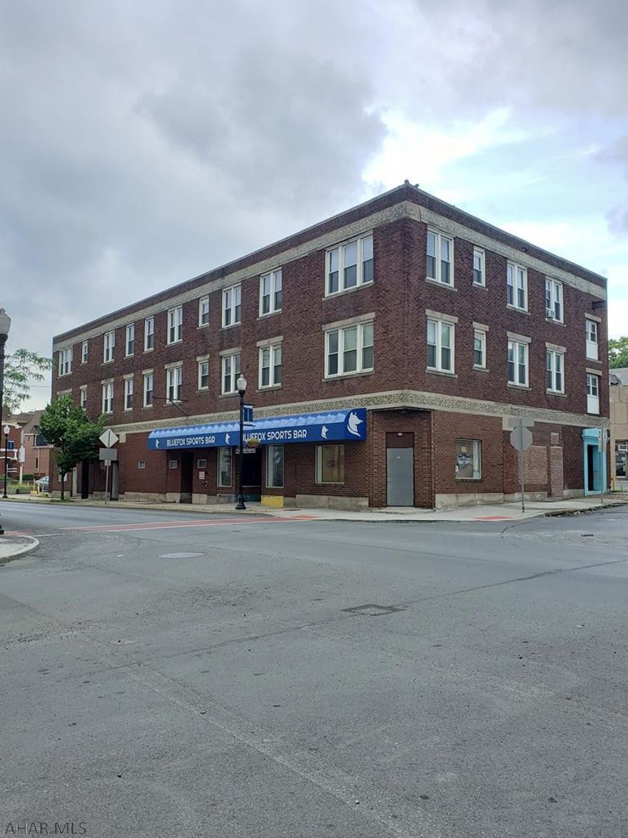 Excellent Investment Opportunity.  This building has all so many possibilities.  The First floor houses the Blue Fox Sports Bar, while the top 2 floors are made up of 8 One-bedroom apartments.  Most of the mechanics have been recently updated.  The Liquor License and all of the bar inventory and equipment are included.