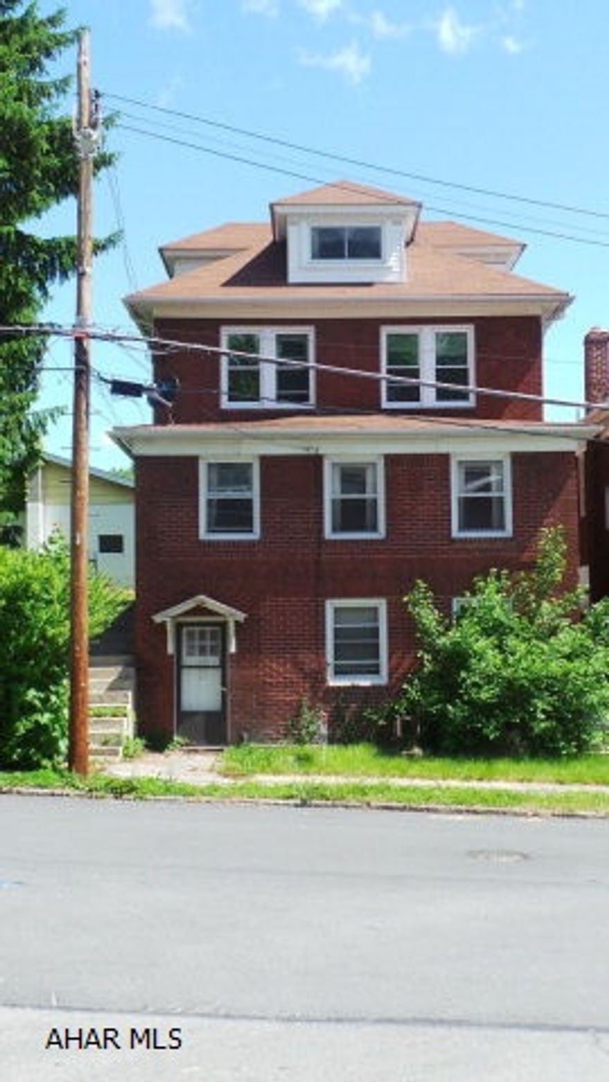 Lg Brick home on double lot with 1 car garage and lg 2+ garage with high ceiling.  Basement level could be office or separate apartment (separate electric).  Garage also has separate electric