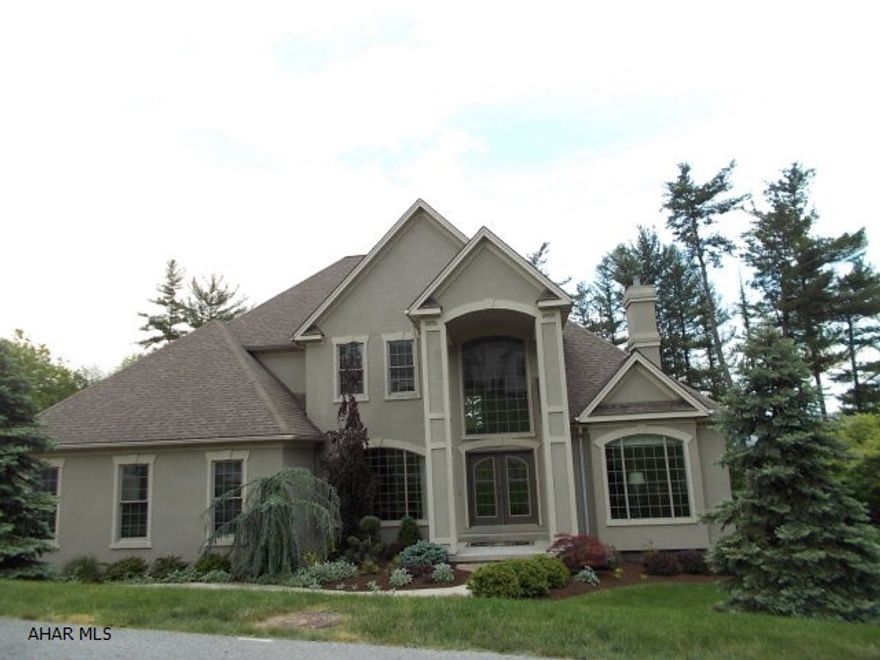 Absolutely stunning home with beautiful architectural features from the beautiful floor to ceiling fireplace to the custom designed gourmet kitchen...Lovely Brazilian cherry floors thoughout main living areas. Terrific family room on lower level with exercise room, built in bookcases, bathroom with steam shower..opening to patio with hot tub. Great room with floor to ceiling windows allows you to enjoy the views of the beautifully landscaped yard with cascading waterfall and pond. Enjoy the views of the town from the back deck and private Master Bedroom balcony while  enjoying all the privacy this wonderful home brings. Adjoining lot in Fox Hollow is also for sale. Tax ID #2-14 5-154 on a separate listing.