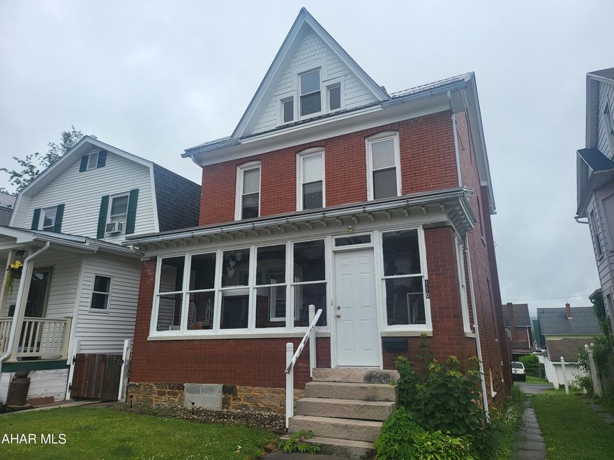 All brick 2.5 story with newer metal roof and replacement windows! Blacktop off street parking and small garage. Used as student housing. Great investment opportunity!