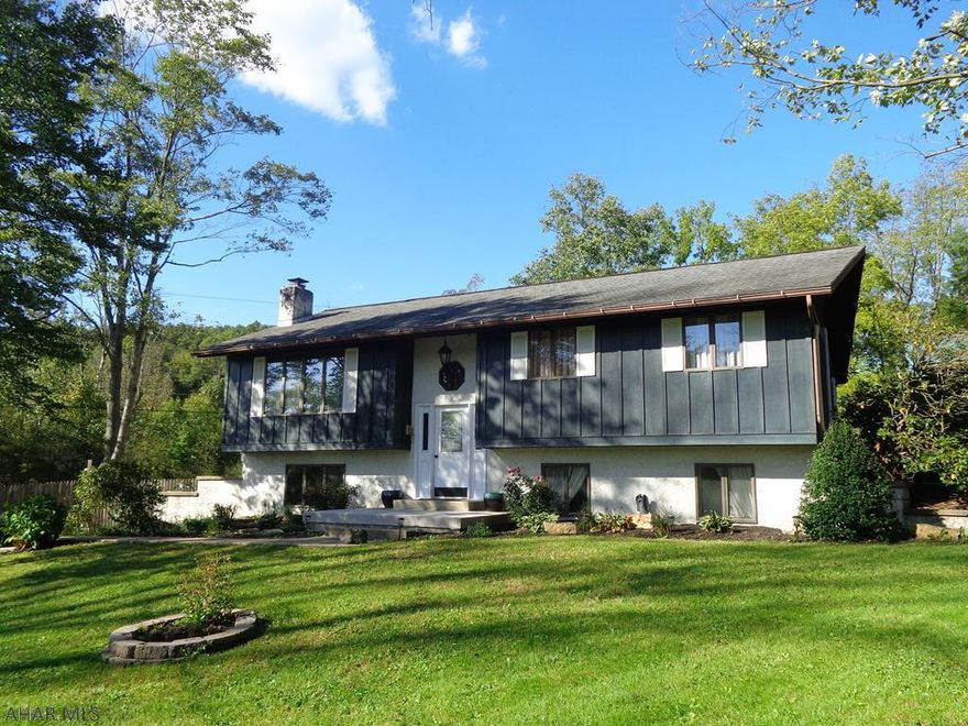 Nice fit for a big family!  Looking for a home out of town but still close to everything?  This is it!  4 Bedroom, 3 Bath, 2 Car garage plus a carport on .69 acres.  The rustic spacious basement has Hickory beams & a fireplace.  New septic system & 3 new mini splits provide A/C & warmth.  Whole house fan.  Wrap around deck.  Around entire property is a underground animal fence.  2 fire pits & a pig roaster.