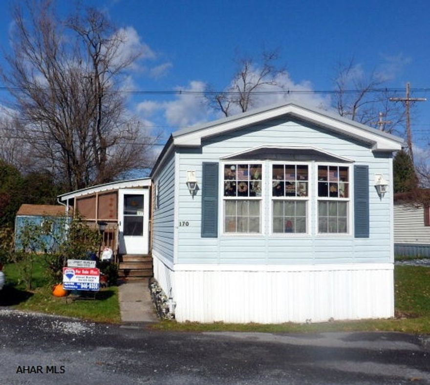 1997 Commodore 14x72 - 2 bedrooms, 1 bath, living room with vaulted ceiling, kitchen with island and appliances, large front window overlooking dining area with built in cupboards and counters on two sides, laundry with washer and dryer, spacious bedrooms and bath with double bowl sink. Nice, side screened in porch and shed. Tilted windows, new carpet and new galvanized roof. Included: NEW living room sofa, two reclining chairs and appliances. Lot rent is $272/mo, includes sewer, trash is separate $72 every 3 mo. Antis Township - Cul De Sac. Miller Ct., Lot 14.