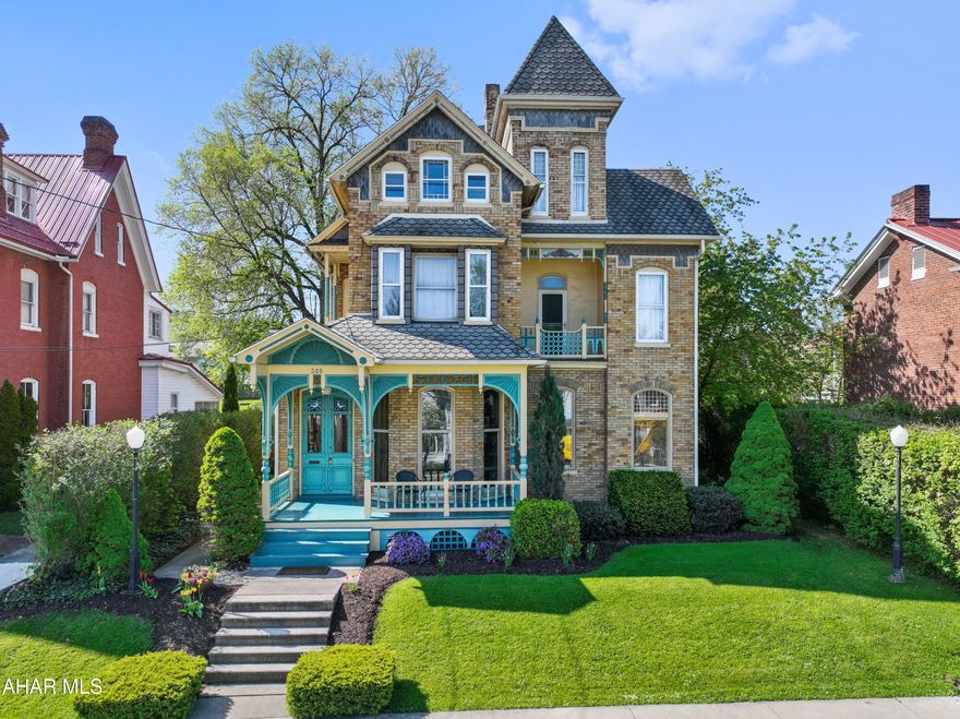 Magnificent and remarkable gold brick Victorian home resting in the heart of historic Bedford, PA!! Stepping into this grand home, you will find a true double door foyer with colorful stained glass, stunning hand crafted wood coffered ceiling and walls, and a meticulously detailed one of a kind open staircase; a true arched door sitting room; great room with floor to ceiling round top windows; formal dining room with pocket doors that's perfect for get-togethers and entertaining; kitchen with cherry cabinets and stainless steel appliances; laundry room/pantry and a full bath. The second level of this amazing home offers three bedrooms; second story balconies with townscape and mountain views; and three bathrooms. Entering the third level, you will find two finished rooms for additional guests, office or studio space; and a large separate storage area. Relax on the grand front porch with your morning coffee or unwind on the rear concrete patio overlooking the manicured lawn, landscape and raised garden beds. At the rear of the lot, you will find a large detached garage with second level accessory unit perfect for an in-law suite, guest quarter, or rental apartment. The first floor is used by the owners for garage and workshop space. The accessory unit, with a separate ground level entrance foyer, has an eat-in kitchen, living room with balcony, one bedroom, one bathroom and a laundry room. Accessory unit is currently tenant occupied with a month to month lease for $1,200 per month plus electric and gas. This property is centrally located just blocks from the downtown area; restaurants and shops; the Heritage Trail; Omni Bedford Springs Resorts and Bedford Elks Country Club.
