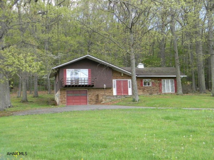 Fashionable brick/vinyl split level on serene 1.7 shaded acres with extended pastoral and mountain views. Featuring vaulted ceilings, large living room with brick fire place, master bedroom with view deck and central VAC. Even more, a shaded rear deck, integral garage and 2 wells allowing for plentiful water. Drive-by this eye-catcher and see for yourself.