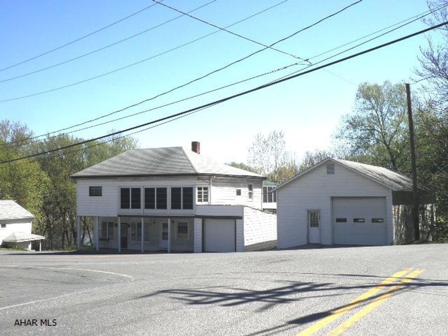 Main Bldg- 2 storefronts (1 was former beauty salon); nice 2-BR living qtrs; attach.garage/storage w/1 OHD; detached 24'+- x 50'+- garage w/full base. & OH doors; 2-spot trailer park site (trailers owned by tenants) Trailer sites - ea. pays $122/month & includes well water & city sewer. 1 Well for entire prop.  Main Bldg.: 3 sewer taps, 2 elect.water heaters, 3 elect. meters, 1 OFA furnace w/ 1 thermostat (in liv.qtrs.)  Items included in main bldg.: 1 elect.range/oven, 1 frig, 1 dishwasher, 1 garbage disposal, 1 washer & 1 dryer.  Trailer site - 2 sewer taps; 2 elect. meters.  Contact list agency per PA Turnpike Commission letter. Square feet approximate.  Survey & flood elev. certificate avail. Excellent opportunity - 6 rental units possible.