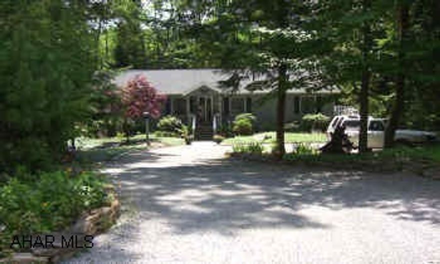 A beautiful home surrounded by lovely landscaping, screened porch in the back overlooks a small lake - great for fishing, wrap around deck with tons of storage underneath, 3 BR, 2.75 BA, beautiful stone FP in great room, & additional FP in FR, large kitchen with island & skylights.