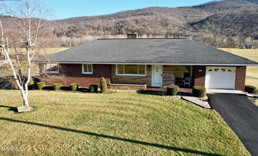 Immaculately maintained home on 5.26 acres.  The spacious ranch allows one to enjoy an updated kitchen with panoramic views of the Allegheny mountains.  The home is spacious and inviting with tons of natural light.  Central air and both wood and oil heat add great conveniences.    Friends and family will enjoy the finished lower level with bathroom, recreation room and walk out to a lovely covered porch and a delightful setting. The lower level also offers tons of bonus space.  Hard to find level acreage with two very large garages with tons of storage and amazing possibilities make this a home that will not last long.