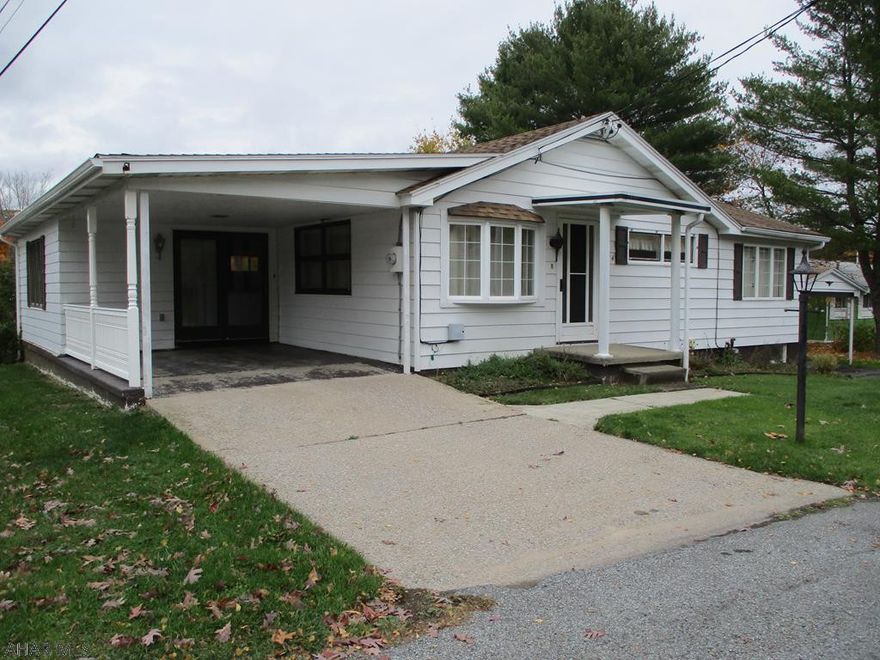 This wonderful one-story home is ready for your special touches.  Spacious open kitchen and dining room area with many built-ins.  Brand new floor covering in the dining room.  The breakfast bar is perfect for quick snacks too.   Master bedroom features  newer private bath with walk-in shower, new flooring.    Large enclosed porch  off the dining room offers space for games, picnic-style meals or just relaxing on warm summer evenings.  The lot is nearly level.  A detached garage  is included.  There are two carports and attached storage shed .  Vinyl sided for easy exterior maintenance.  Now on public water, but the original well is active and can be used for outdoor watering.  Large level rear yard for children or pets.  NEW FURNACE INSTALLED 12/07/2020.