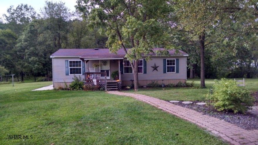 5.23 acres with adorable doublewide. Property backs up to Patterson Run Creek. Private setting, large yard and access to creek. Outbuildings and great location.