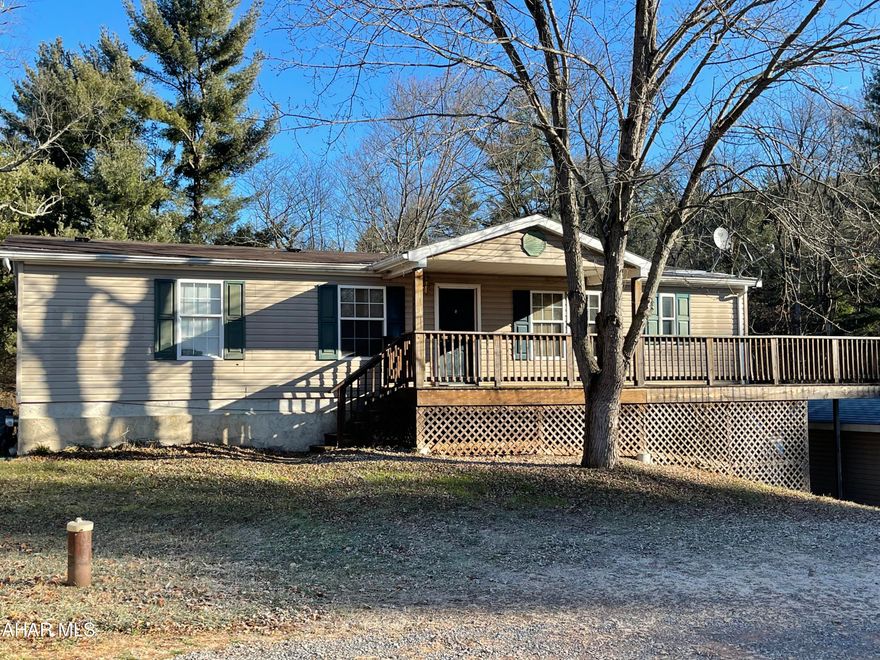 SELLER IS GIVING A $4,000 CREDIT TOWARDS CARPET/WINDOW. Large doublewide, with finished basement and did I mention views?  3 spacious bedrooms, 2 full baths, 1 half bath.  A lot of living area including living room, kitchen with breakfast bar, dining room with fireplace, bonus room and basement. Large recreation room, utility room and bonus room with outside entrance door.  Enjoy sunsets on your deck while entertaining after a fun pool day in your inground swimming pool.  Flat lawn surrounded by woods.  2 car garage and plenty of parking. Central air and oil heat.  Location!!!  5 minutes away from Breezewood including major highways PA Turnpike and I-70. Come see what all 935 Barton Road has to offer! SELLER IS GIVING A $4,000 CREDIT TOWARDS CARPET/WINDOW.