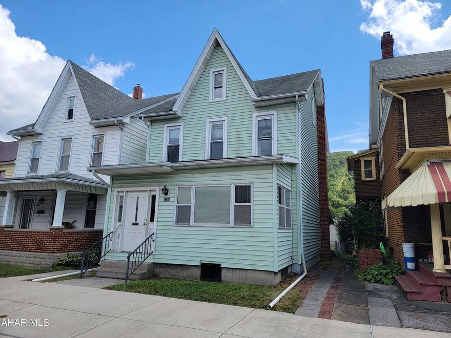 2 1/2 story, 4 bedroom home with 3 baths. Two bedrooms on 2nd floor and two bedrooms in heated 3rd floor. Brick fireplace in dining room. Hardwood floors. Multi-fuel (Gas/Coal/Wood) hot water heating system. 1st floor sunroom and mud room. Covered rear patio. 2 car detached garage.