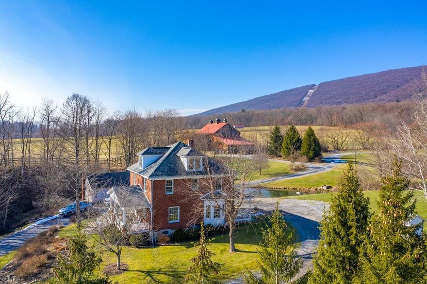 Classic, elegant and comfortable. Splendidly remodeled 4BR, 3.5BA all brick farmhouse has been a landmark of Scotch Valley for over a century. Vintage charm can be seen in every part of the property but is featured in the house through its beautifully restored original woodwork, hardwoods, and pocket doors. Every modern idea was thought of for convenience including a granite and stainless steel trimmed kitchen, first floor laundry, step in shower, to name a few amenities. Bonuses include multiple ponds, covered front porches and a stone dining hall that features an exceptional wooden tavern table and an hearth fireplace. Even the barn has been renovated. Stalls with modern conveniences such as automatic waterers and spray system and a groom's quarters. 163+ acres of fields and woods.