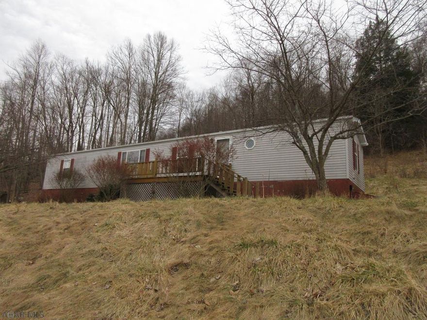 Coalport mobile home on nearly 1 full acre with detached 2 car garage. Large overhead door on one bay will hold larger RV or large camper. Beautiful oak kitchen with island, beautiful master suite. Large front and rear decks Home is in decent shape, but does need some work. AS-IS sale. Seller will make no repairs.