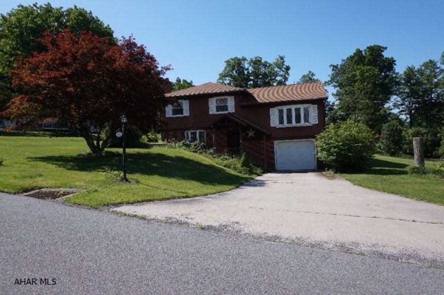 Great setting! Great 3 bedroom, 1.5 bath, split level on large corner lot!  Spacious family room with fireplace; kitchen with dining area. Central air. Sun room, 1 car garage, nice in-ground swimming pool. View. Take a look at this property!