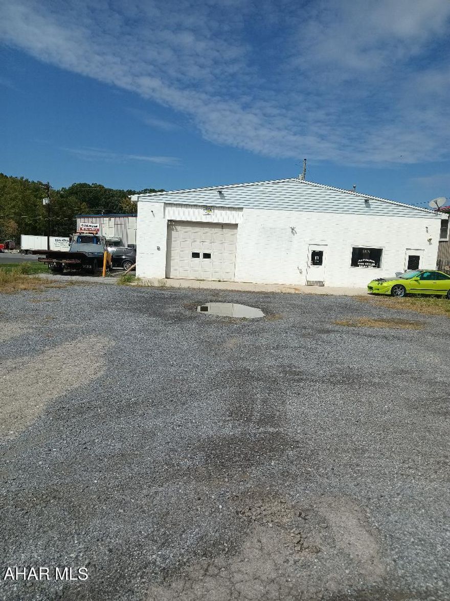 Approximately 3000 sq. foot building was used for auto body repairs. Also a second floor 2 bedroom apartment. Live or rent the top and use the 1st floor for your business