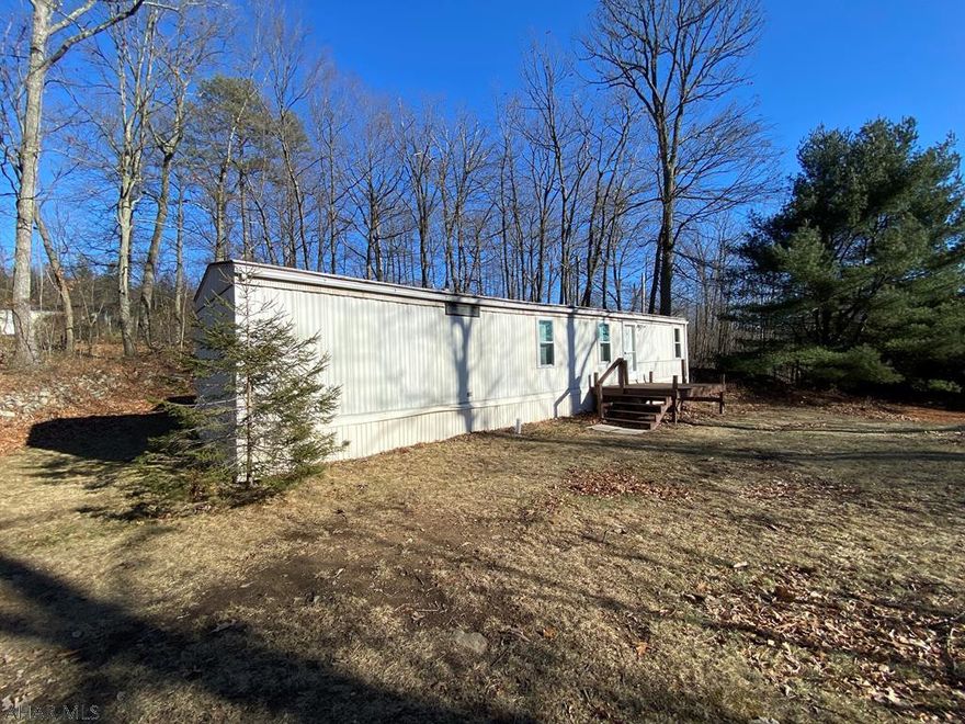 Just shy of 2.5 private acres in Breezewood Park. Close to I-70, 915 and just off Route 30. Convenient location with lots of seclusion! Used as a vacation property, could easily be a full time residence or hunting cabin/getaway. Two bedroom, 1 full bath single-wide with eat-in kitchen. Living room, laundry and porches. Large double lot with multiple driveway entrances. Fire pit and spacious two car garage. Lot's of possibilities here. Call for your showing today!