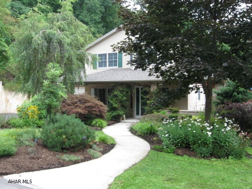 Gracious Seclusion near Hollidaysburg Boro.  Fantastic views of mountain, valley and river from wrap around deck and gazebo. Stone fountain spills into georgeous in ground pool surrounded by lush landscaping and flowering gardens. Welcoming living room with loft offers rustic and cozy elegance with vaulted beamed ceiling, sky lights and stone fireplace.  Large modern eat in kitchen has glass pane cabinet doors and center island.  Bonus room can serve as office or 1st floor bedroom.  Master suite includes separate study with balcony, walk in closet and large bath. Semi finished daylight basement has a hot tub and room for large family or game room. Custom chicken coop for organic fresh eggs! To perserve the privacy of this secluded area NO DRIVEBYS. Seller has bid to improve road in spring.