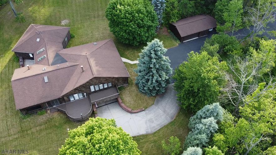 Cedar Contemporary home on over 4 acres with fantastic views in the Hollidaysburg school district. These homes were built for entertaining with open spaces. Home is heated with geothermal heat for low heat bills. A see through wood fireplace is great for atmosphere and additional heat source. Spiral staircase leads to a full finished basement with a wine cellar. Indoor inground pool and exercise area has a full bath. Home also features a master bedroom and bathroom. Detached two car garage for additional parking and storage. Seller related to agent.