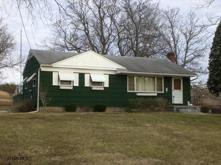 One-story cedar shake sided home on over an acre. Shingle roof, thermo pane windows & lg rear deck. Three bedrooms, kitchen w/ updated oak cabinets, dining room, newly remodeled bath & living room w/ picture window. Oil FA furnace less than 1 yr old. Wood burning stove & new appliances that stay. Public sewer w/ 3 separate lots that total 1.177 acres. Detached 4 car garage.