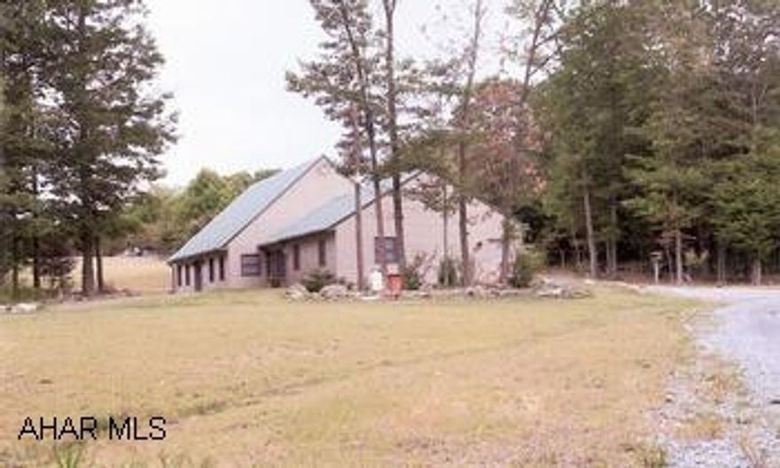 Want complete privacy and serenity? Then this house on 27.5 acres is for you! Private drive leads to this fantastic house, many upscale amenities. Vinyl-sided w/stone accents, lots of windows, hardwood floors, ceiling fans, gas fireplace, chandelier, custom kitchen, cathedral ceilings in great room, dining room doors lead to patio, living room has French Doors. Upstairs has additional 735 sq ft w/partially finished bedroom, full bath, den, bonus room. Beautifully landscaped w/flower beds bordered with stone walls. Yard areas surrounded by woods. Additional large building has 1-car garage, large workshop and full bath, upstairs guest apartment w/kitchen living/dining room, bedroom and full bath.