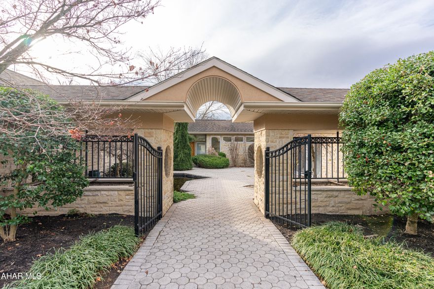 Truly one of a kind in prestigious Sylvan Hills.   Drive down the concrete drive to a gated entrance and 3 car garage.   The home features spacious one story living in a quiet setting. Crown moldings, in floor heat, walk in closets, two gas fireplaces.  Huge owner's suite features walk in shower, jet tub, bidet and a private walk out patio, Beautifully decorated with walls/cabinetry in several areas painted by a local artist. Be sure to note the many built-in bookcases and etagere spaces in the living areas.   New four zone furnace.   The garage has a large storage room on upper level.  Several outdoor seating areas for summer entertaining, nicely landscaped.   Two adjacent lots available for purchase @ $149900 to provide maximum privacy.